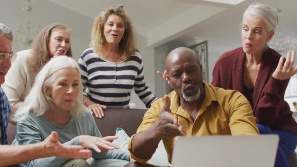 Animation of happy diverse female and male senior friends having video call on laptop