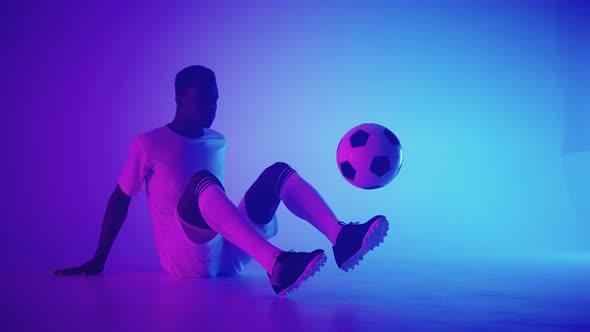 Black African Man Freestyle or Professional Soccer Player Practicing with Football Ball Juggling on