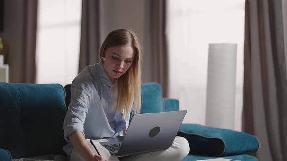 Serious Young Woman Freelancer Working on Freelance From Home Typing Email on Laptop Focused Girl