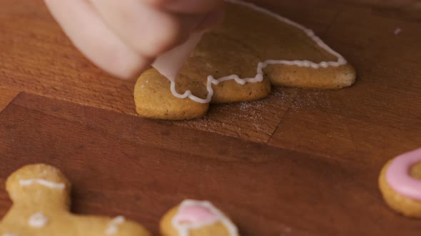 Decorating Gingerbread Cookies in the Shape of Christmas Tree with Royal Icing