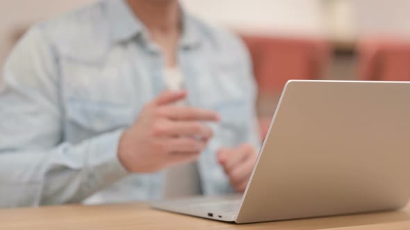 Man Showing Hand Shake Sign While Using Laptop Close Up