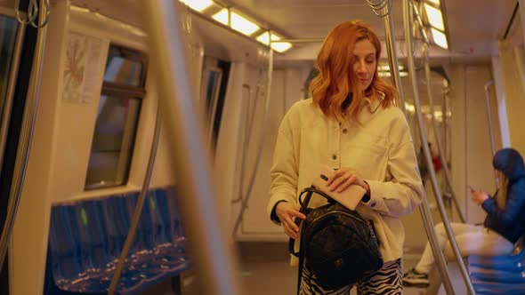 Woman enters a train on the subway station.