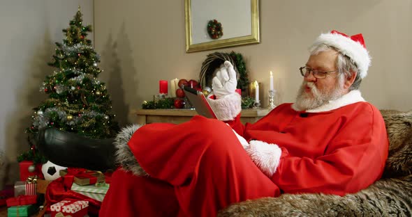 Santa claus looking at clipboard