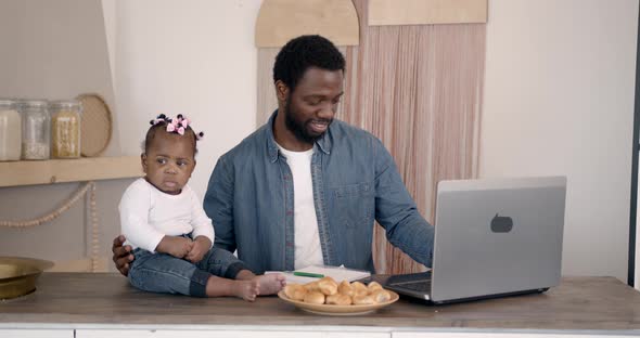 Young Family Using a Laptop During Breakfast