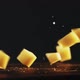 Pieces of Hard Cheese with Crumbles Fall Down Onto Table - VideoHive Item for Sale