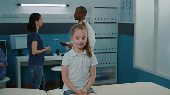 Portrait of Little Girl Waiting to Do Medical Examination with Doctor