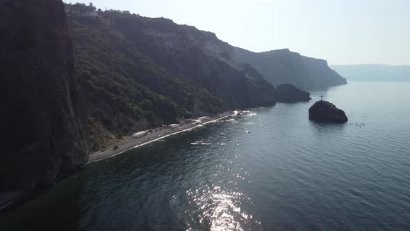 Aerial View From Above on Calm Azure Sea and Volcanic Rocky Shores