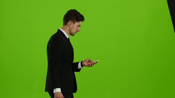 Man Goes To Work and Talks on the Phone. Green Screen. Side View