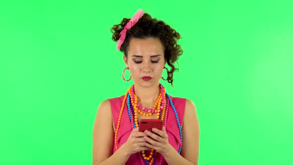 Young Woman Texting on Her Phone on Green Screen