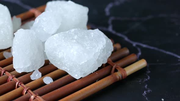 Sugar Candy on a Wooden Board on Black Background