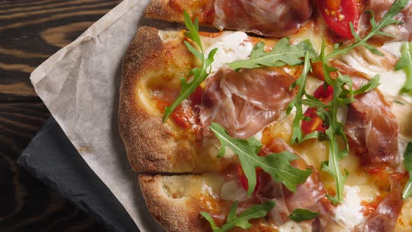 Prosciutto Pizza with Strachatella Cheese Tomatoes and Arugula Leaves