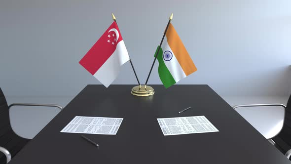 Flags of Singapore and India on the Table