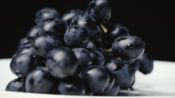 A Bunch of Blue Wet Grapes Spinning Slowly