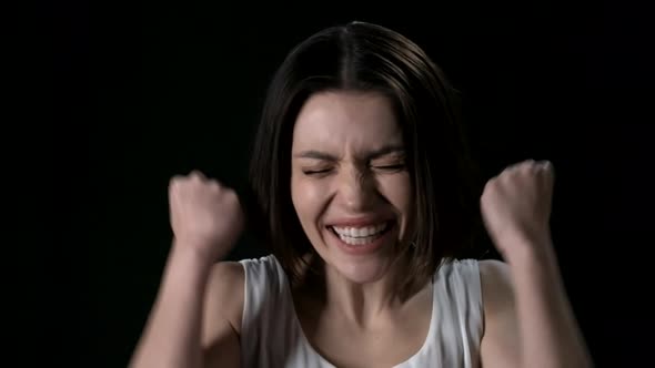 Excited Brunette on Black Background