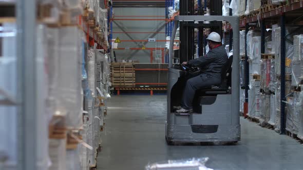 Warehouse Worker Riding a Forklift