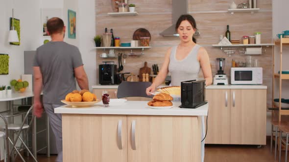 Housewife in Pajamas Preparing Breakfast