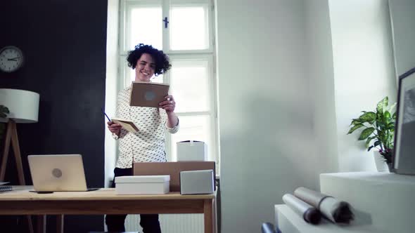 Young online shop owner checking delivery and parcels