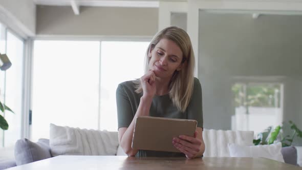 Woman using digital tablet at home