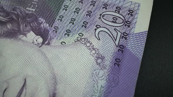 Fifty British Pound paper banknote in close up macro view dolly shot.