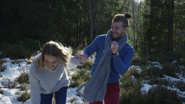 Young couple playing with snow