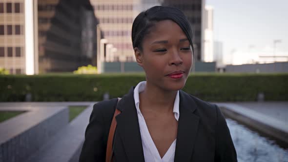 Mixed ethnicity business woman walking