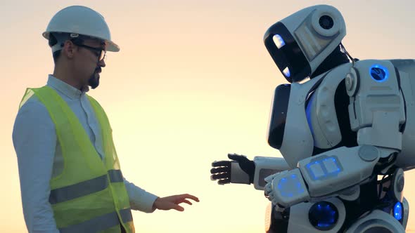 Human-like Robot's Setting Are Being Regulated By an Engineer in a Hardhat