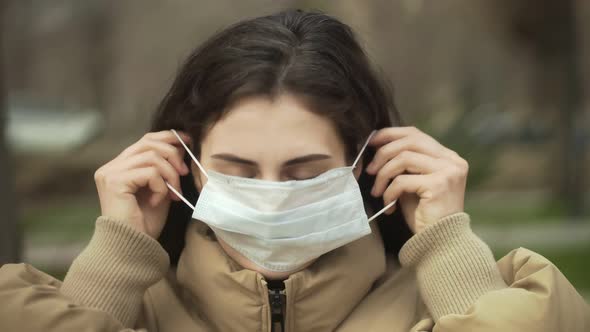 Woman Puts on a Mask for Protection