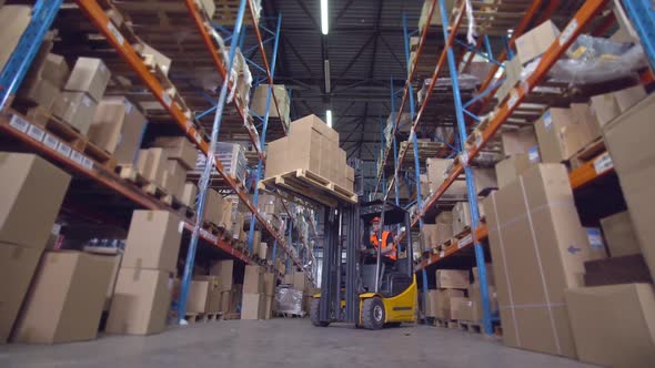 Forklift Operator at Work in Storehouse