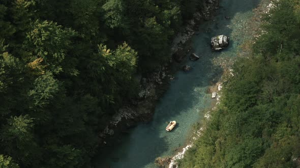 Small boat sailing along the forest on a narrow river