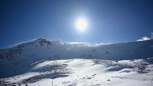 Snow blowing off of Colorado Rocky Mountain peaks during the day, static