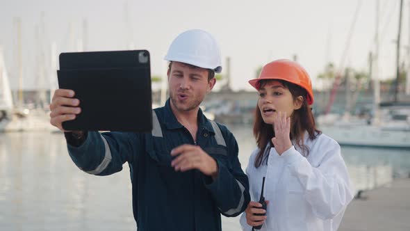 Yacht Club Employees Using Digital Tablet in Marina