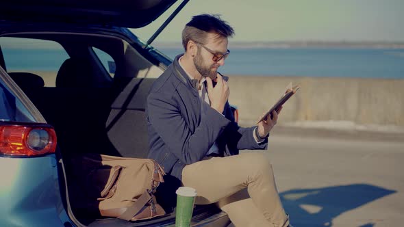 Stylish Businessman Reading Book After Hard Working Day. Businessman Reading Book In Park.