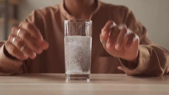 Close Up Sparkling Water Glass with Dissolving Effervescent Aspirin Pill