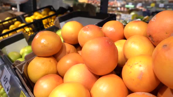 Pick Up the Fruit at the Store. Man Chooses Fresh CITRUS To Buy.