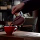 Cinematic Slow Motion Pouring Herbal Tea in Red Cup from Pink Tea Pot - VideoHive Item for Sale