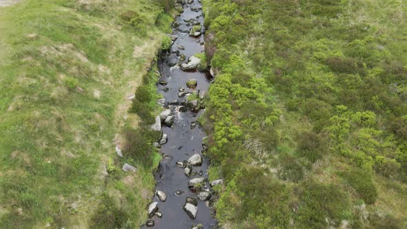 Gratifying lush water stream flowing Wicklow Ireland aerial