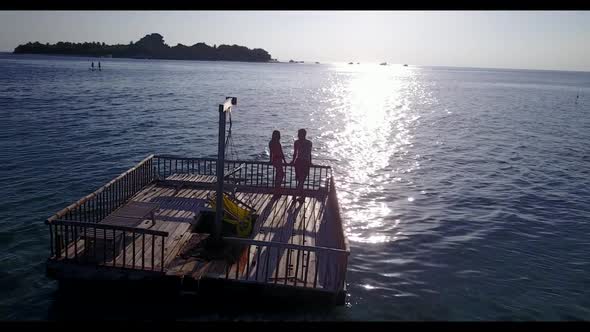 Family of two tan on perfect bay beach journey by blue sea with bright sandy background of the Maldi