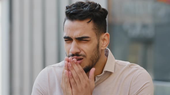 Close Up Sick Hispanic Business Man Sneezing on City Street Background