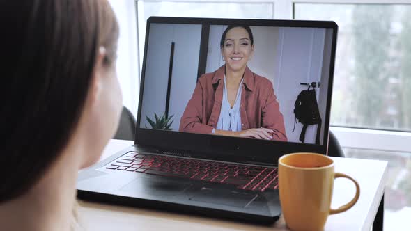 Young Woman Call While Looking at Computer Screen Following Professor Teach on Video Call. Student