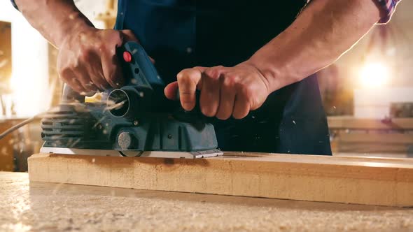 Close Up of a Wooden Block Getting Sawn in Slow Motion