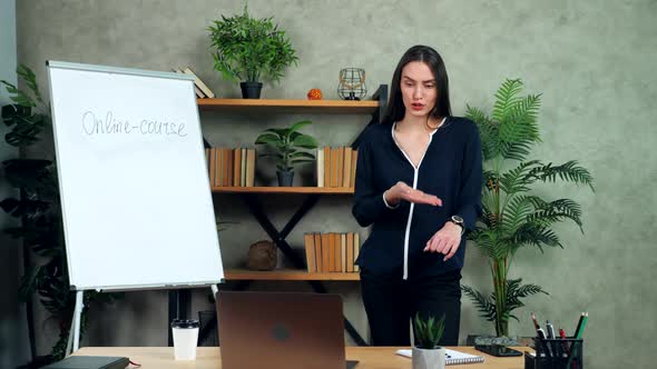 Hurry businesswoman listens online report laptop, pointing showing at clock