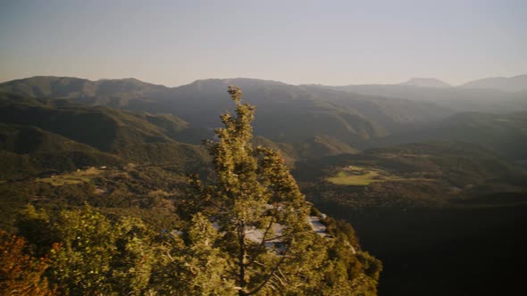 Sensational scenic view of mountain ranges in green rural countryside landscape with bright white su