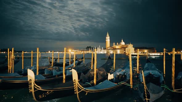 tilt up shot of moonlit gondolas at piazza san marco, venice