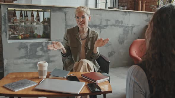 Enthusiastic Young Woman Talking to Business Partners