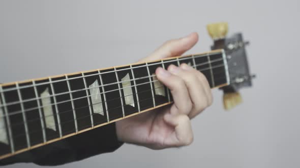 Man hands playing electric guitar fret board with headstock and strings.Musician instrument concept.