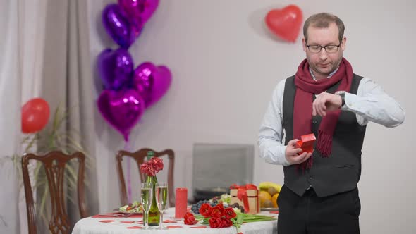 Portrait of Worried Man Getting Ready to Propose on Valentine's Day Checking Time on Watch Looking