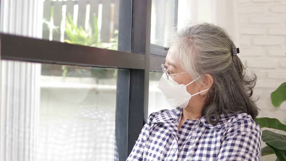 Asian elderly woman Stay at home to prevent infection.