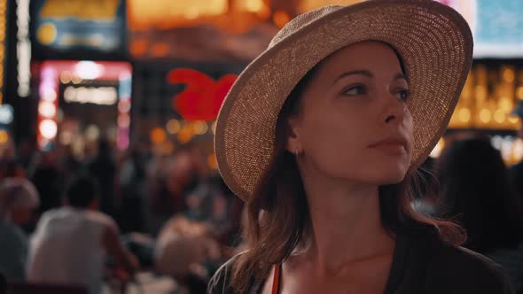 Smiling woman in Times Square in New York City at night