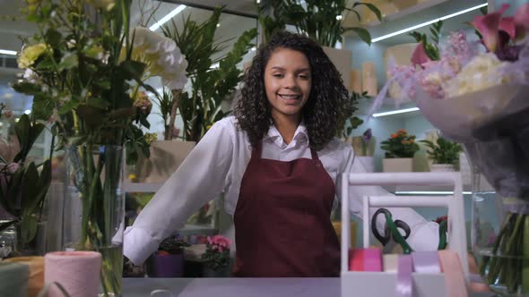 Smiling Woman Florist Looking at Camera in Shop