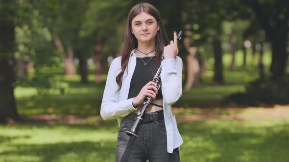 Portrait of a Georgian Girl with a Portrait in a Park in the Summer